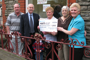 Caerphily MP Wayne David is presented with a cheque by members of Abertridwr Community Church.