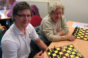 Lewis pupils Liam Mahoney teaching chess at the 50+ Club.