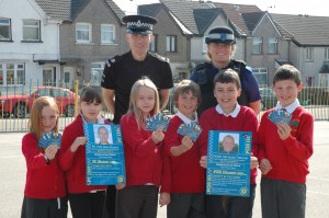 PC Dave Abrams and PCSO Susan Falconer with pupils from Cefn Fforest Primary and some of the cards they will be collecting