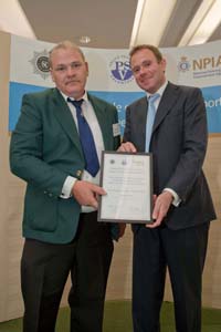 WayneTudball, left, receives his commendation from Police Minister Nick Herbert