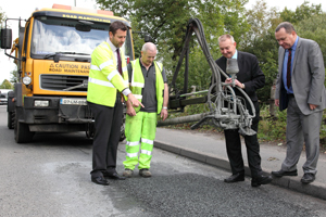Cllr Rob Gough and Cllr Lindsay Whittle see the new 'jet patching' equipment in action with CCBC highways staff