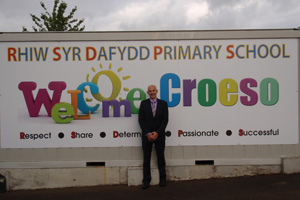 Mike Glavin, head teacher of Rhiw Syr Dafydd Primary, outside the new sign that was donated by Draig