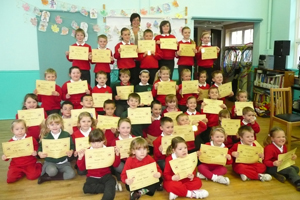 Pupils from Ysgol-y-Lawnt with their certificates for completing Walk to School Month