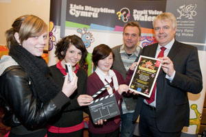 Chelsea Jenkins, Courtney Lewis and Zoe Small from New Tredegar Youth Group receive their prize of £1000 from First Minister Carwyn Jones and director Marc Evans