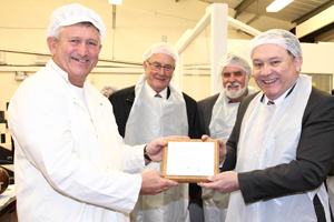 Cllr Lindsay Whittle and CCBC cabinet members hand over a grant-funding plaque to Castle Chocolates in Bedwas