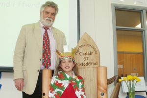 Nia Parsons is crowned Bard at the Rhiw-Syr-Dafydd School Eisteddfod by Cllr Allan Pritchard