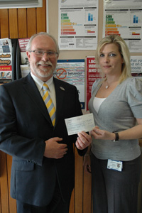 DC Becky Hayward presenting a cheque back to John Bennet, Chief Executive of bibic