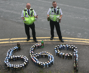 Community Safety Wardens with the confiscated drink