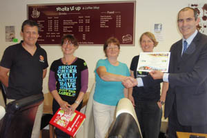 Members of the Caerphilly Fairtrade Group are presented their Fairtrade certificate by town centre development manager Andrew Highway