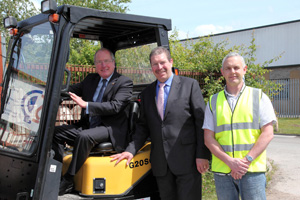 Martyn Fear and Martin Beechey of Specialist Precast Products show Cllr Ron Davies the fork lift truck they were able to purchase through applying for grant assistance