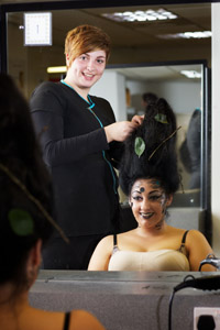 Hairdressing student Emma Hardcastle puts the finishing touches to her “tornado” design, modelled by Sabrina Dimambro