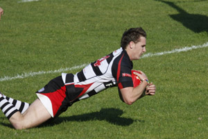 Bedwas winger Tommy Watkins crosses at Tonmawr