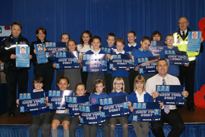  Local officers and Community Safety Warden Alan Davies join pupils at Tir y Berth Primary School and teacher Mr Dan Thwaite