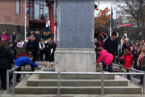 School children lay wreaths at the Armistice Day ceremony in Caerphilly town