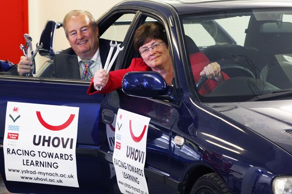 Helen Marshall, UHOVI Director and Bryn Davies, Principal at The College Ystrad Mynach with the cars secured for the new motorsport courses