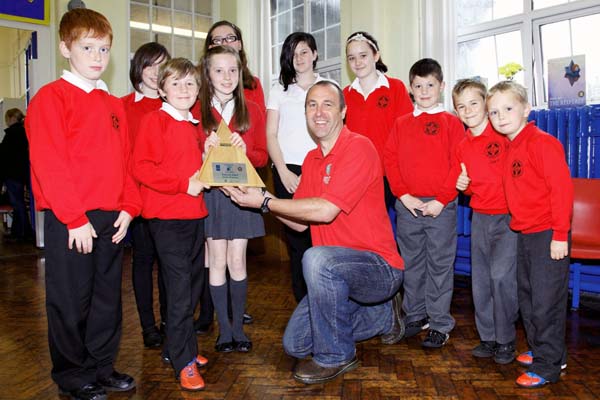 St Gwladys Bargoed pupils with their Eco award and assessor Matthew Bunt