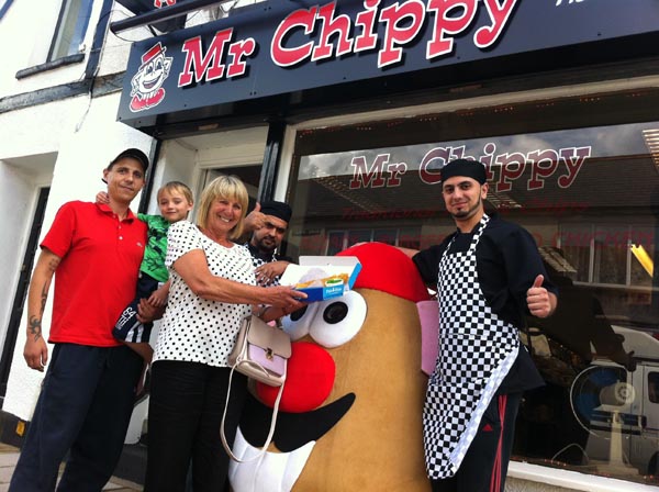 Customers Chris Hobbs, son Michael and mother Pat with Naz and Ibrar Khan outside Mr Chippy in Clive Street, Caerphilly