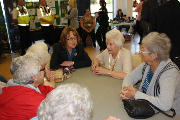 Sarah Rochira, Older People's Commissioner for Wales, speaks with members of the intergenerational club at Lewis School Pengam