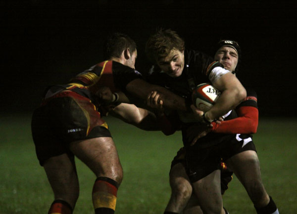 Bedwas winger Matthew John tries to break through two tacklers