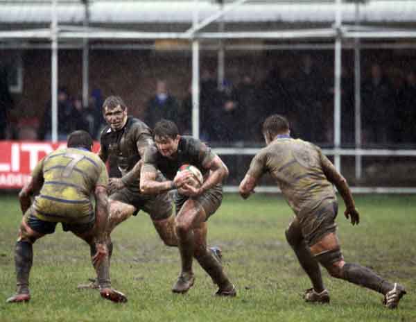 Bedwas outside half Ethan Davies takes on Arthur Ellis (left) and Jonny Vaughan