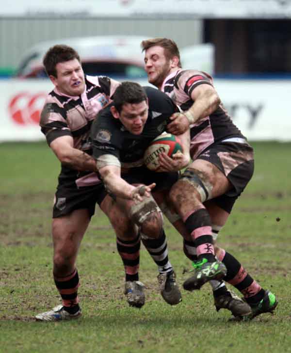 Bedwas captain Phill Sargent breaks through two Cardiff tacklers