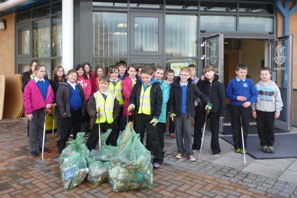 Pupils from St James Primary with some of the bags of litter they collected as part of their clean up