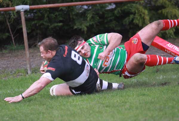 Deri Mattravers crosses for a try despite the attention of a Llandovery defender
