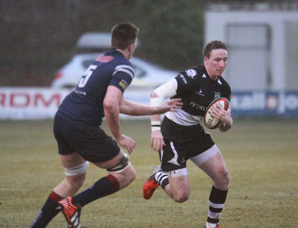 Lewis Hudd takes on Swansea's Rory Thornton