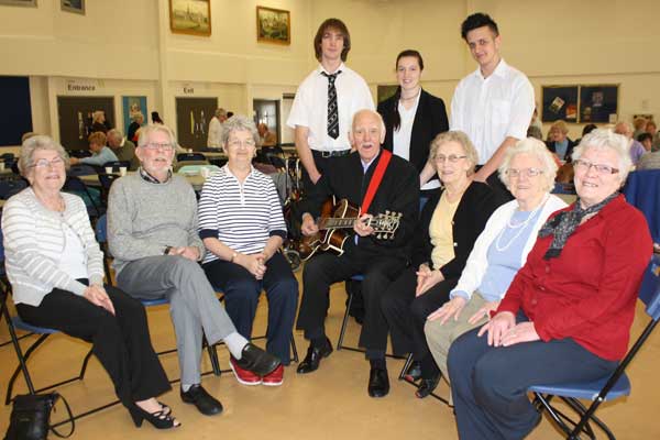 Sixth form students at Lewis School Pengam and some of the local residents who go to the intergenerational club with Stan Stennett