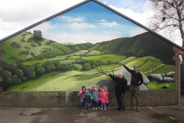 Cllr Dave Poole and artist Bryce Davies unveiling the artwork with members of the local community.