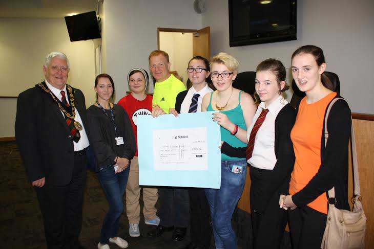INSPIRATIONAL: Youngsters from across Caerphilly county borough, together with Mayor of Caerphilly County Borough Cllr Michael Gray, present a cheque to runner Mark Lewis-Jones