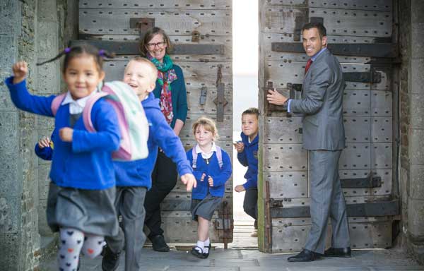 DOORS OPEN: Ken Skates AM and Cadw Chief Executive Kate Clarke let Cwm Primary School pupils into Caerphilly Castle
