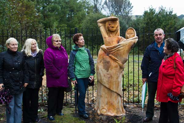 Visitors to Senghenydd’s National Mining Memorial with the new sculpture - Photograph by Carl Jones