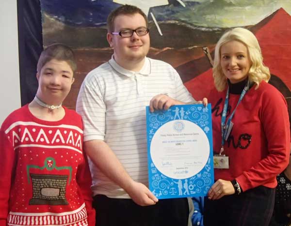 Unicef's Professional Adviser for Wales Sarah Hook (right) presenting learners from Trinity Fields with their award.