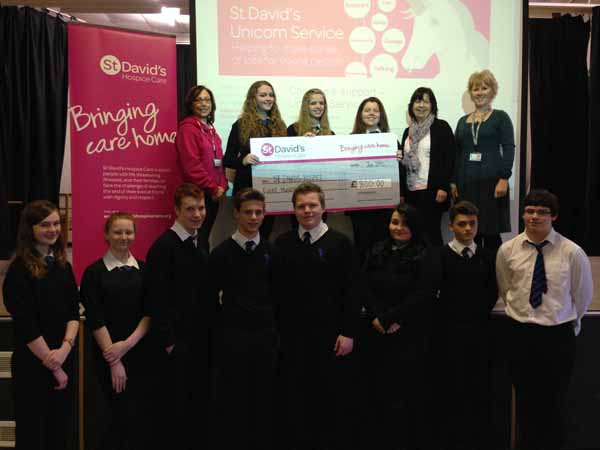 Year 10 students at St Cenydd present a cheque to St David's Hospice