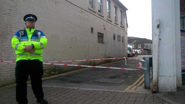 An alleyway leading to the back of the supermarket was also cordoned off