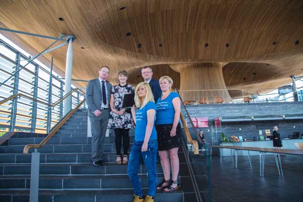 CAMPAIGNERS: Jessica and Julie Bradford handing over their petition to the National Assembly for Wales’s Petitions Committee members.