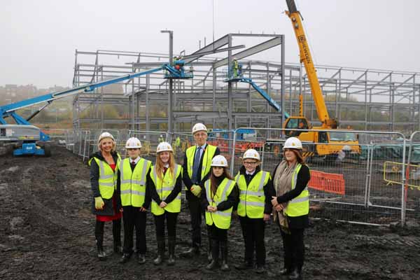 SITE VISIT: Council Leader Cllr Keith Reynolds (centre) joins others on a visit of the school