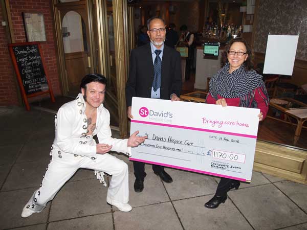 CURRY AND ROCK: Ashraful Haque, with Johnny Elvis, (left) presents a cheque to Franca Nigro of St David’s Hospice