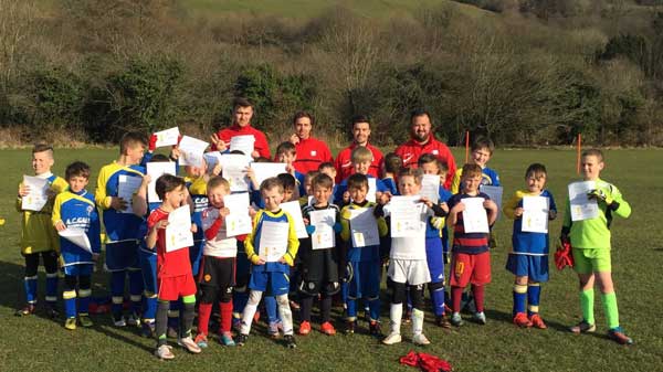 Llanbradach AFC youth players show off their certificates with the student coaches from University of South Wales