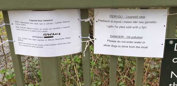 The signs put up around the Castle moat warning visitors about the oil spill 