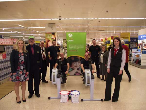 Mayor Cllr Leon Gardiner and Mayor’s Consort Mrs Alma Gardiner with staff from Tesco in Ystrad Mynach and officers from Caerphilly Fire Station at the rowing challenge