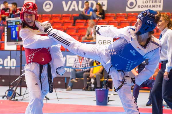 GOLD: Lauren Williams (right) secured the 67kg title with victory over Nur Tatar, from Turkey