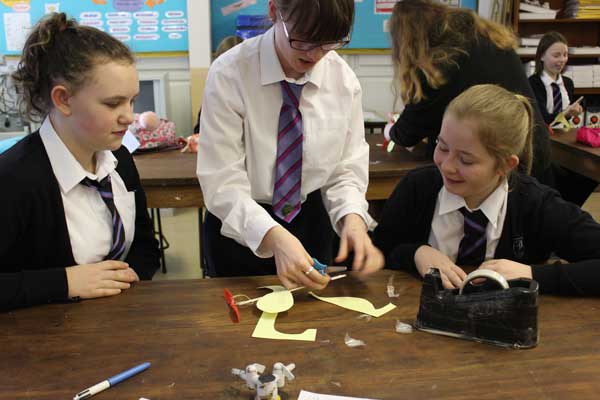 Year 8 pupils with sixth-former Megan Price (centre)