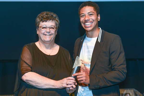 Diane Brookes, from United Welsh, being presented with the Arts and Business award by Casualty actor Luke Bailey