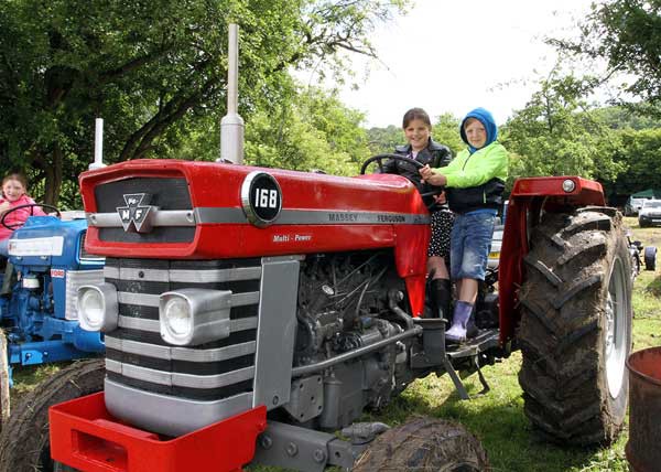 Molly Gleeson and Ben Teale enjoy one of the many tractors on display at the Machen Agricultural Show