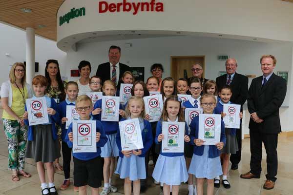 SLOW: Primary School pupils with their speed limit poster designs