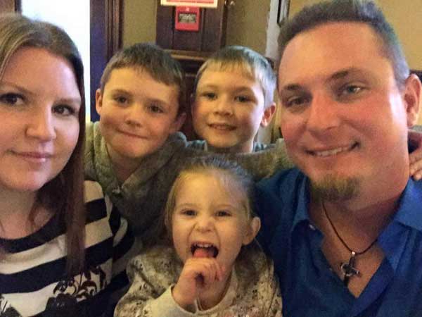 YOU CAN STAY: Jonathan Brown, right, with his family