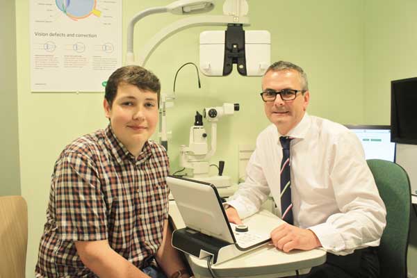 UNEXPECTED: Anthony Jones, 18, with optometrist Robert Evans, at Specsavers Caerphilly