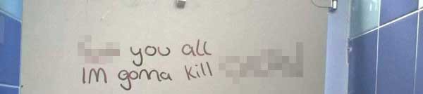 The death threat written on the door of a cubicle in the school's toilets. We have obscured the pupil's name to protect his identity